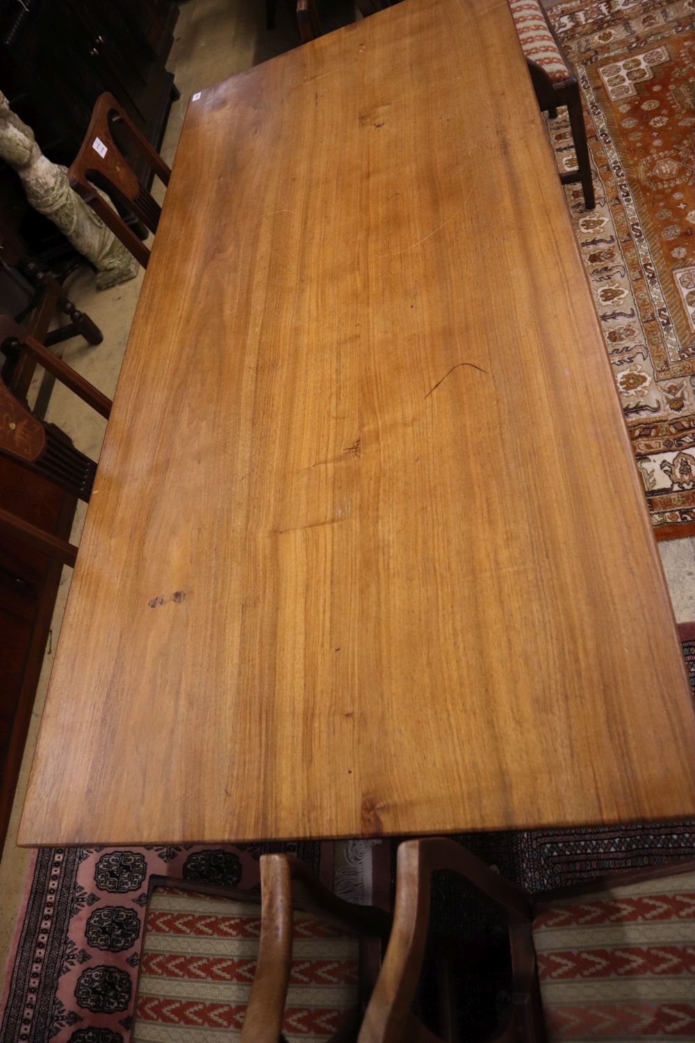 A Gordon Russell walnut dining table, circa 1930, on chamfered double end supports and central stretcher, width 184cm, depth 83cm, heig